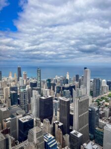 Aerial view of the Chicago skyline with densely packed skyscrapers and Lake Michigan stretching to the horizon
