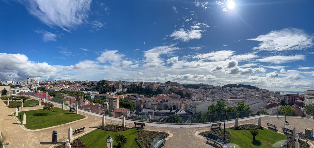 View from a hillside garden viewpoint in Lisbon over the rooftops of Baixa toward the city beyond.